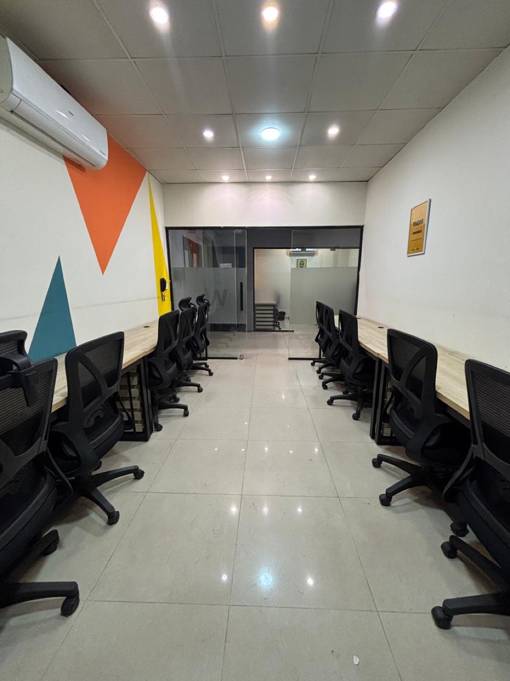 Hallway leading to a glass-walled meeting room