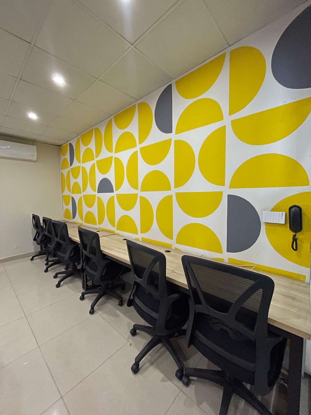 Branded feature wall beside a row of workstations